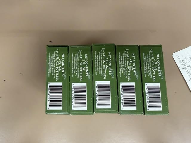 Underberg bottles on shelf close-up showing amber liquid and distinctive packaging