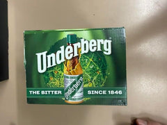 Underberg twelve-bottle pack on bar shelf for sharing with guests