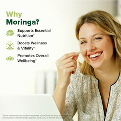 VAHDAM Moringa capsules outer packaging on wooden surface.
