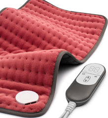 VALGELUIK heating pad on a sofa delivering targeted back and shoulder warmth