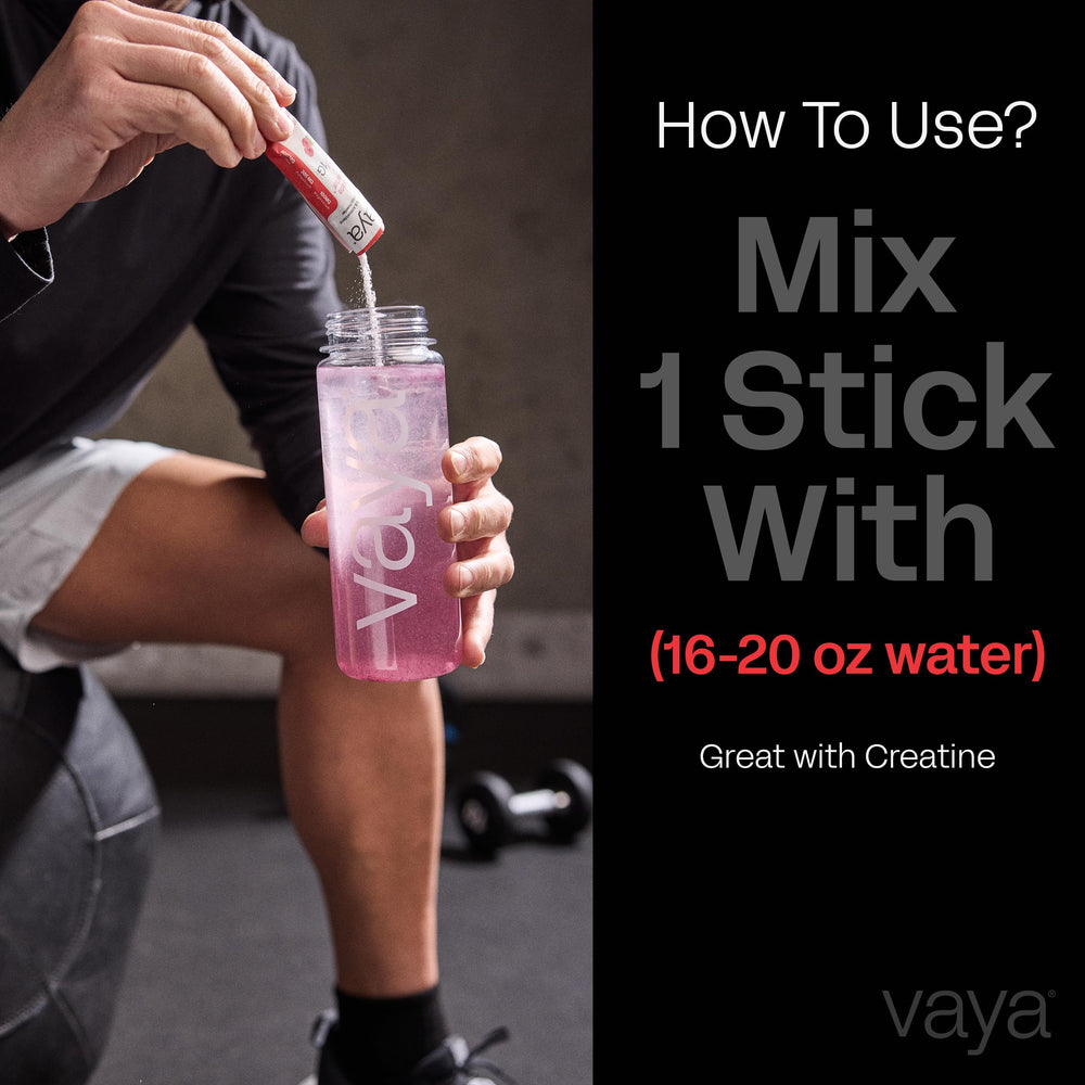 Vaya individual packets beside a glass of prepared drink.