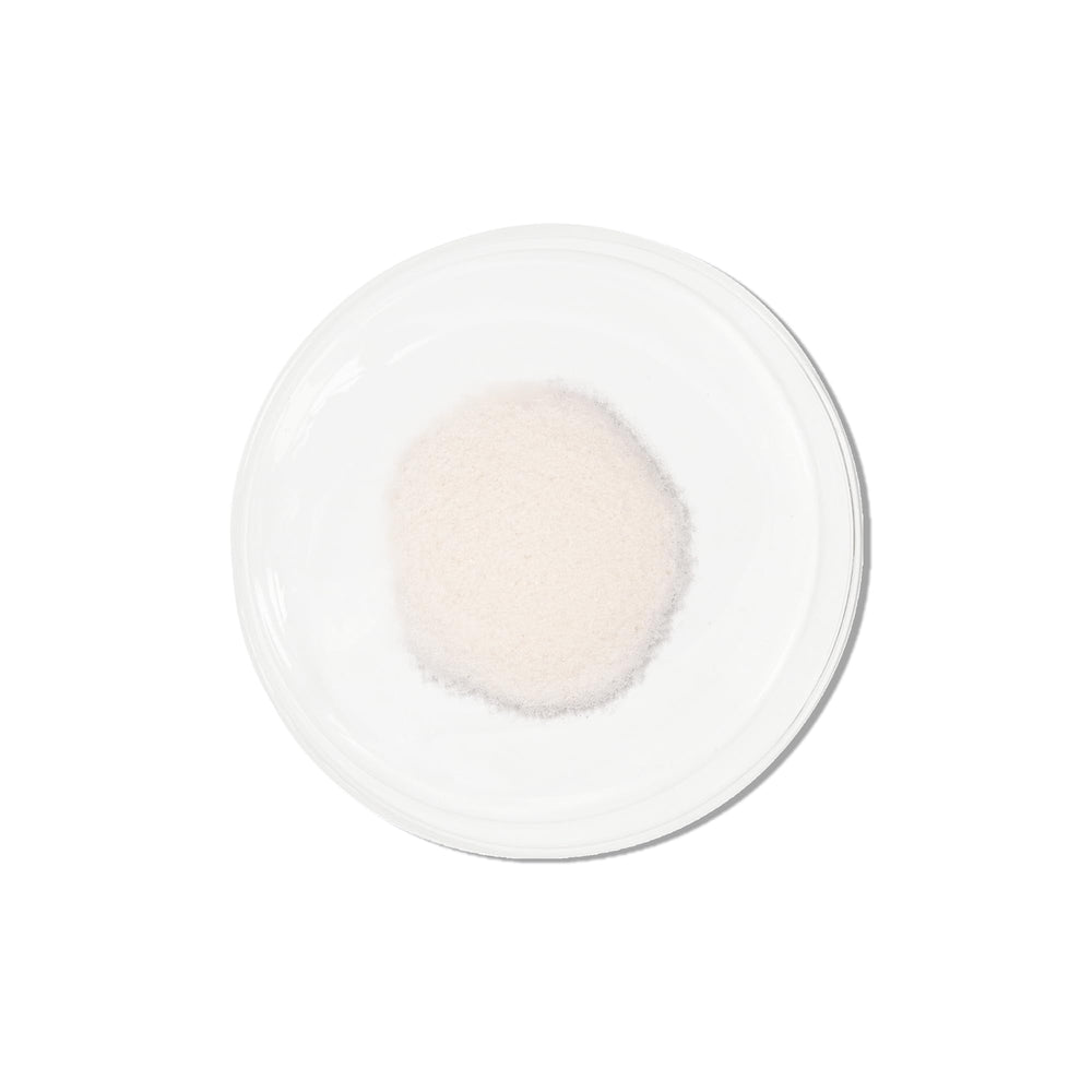 Vida Glow pineapple collagen sachets beside a glass for a convenient beauty routine.