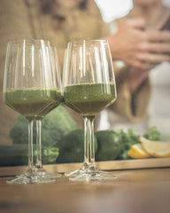 Shaker with a green smoothie made from Mighty Maca Plus to boost energy.