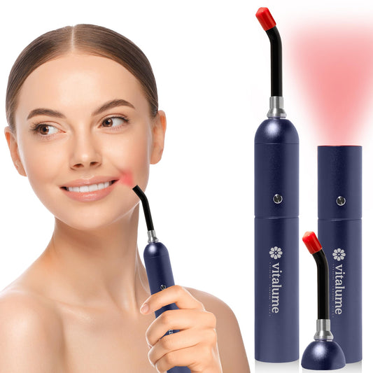 Vitalume red light wand in hand showing a compact design for on-the-go therapy.