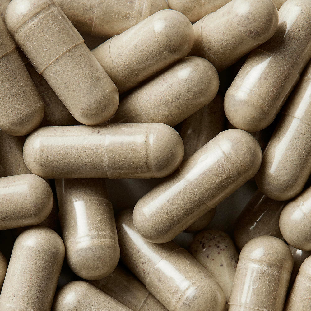WELLBEL Women+ capsules swirl illustrating easy three-capsule daily dosage.