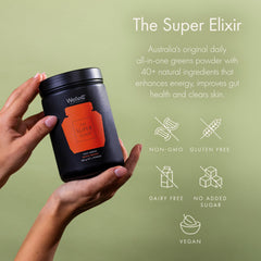 Glass with prepared WelleCo The Super Elixir drink showing a vibrant, inviting color