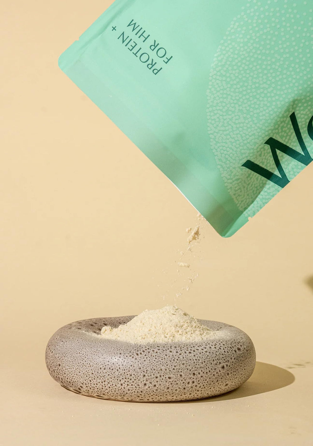 WeNatal Protein for Him being poured into a shake glass for easy energy