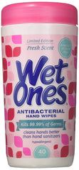 Wet Ones Fresh Scent canister in car cup holder for on-the-go sanitizing.