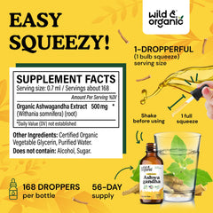 Wild & Organic Ashwagandha Drops dropper pouring into glass for use.