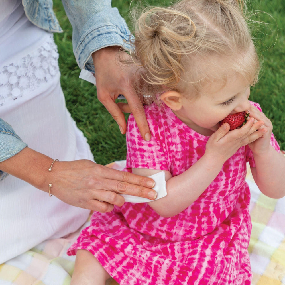 YAYA ORGANICS family outdoors using the spray for natural protection