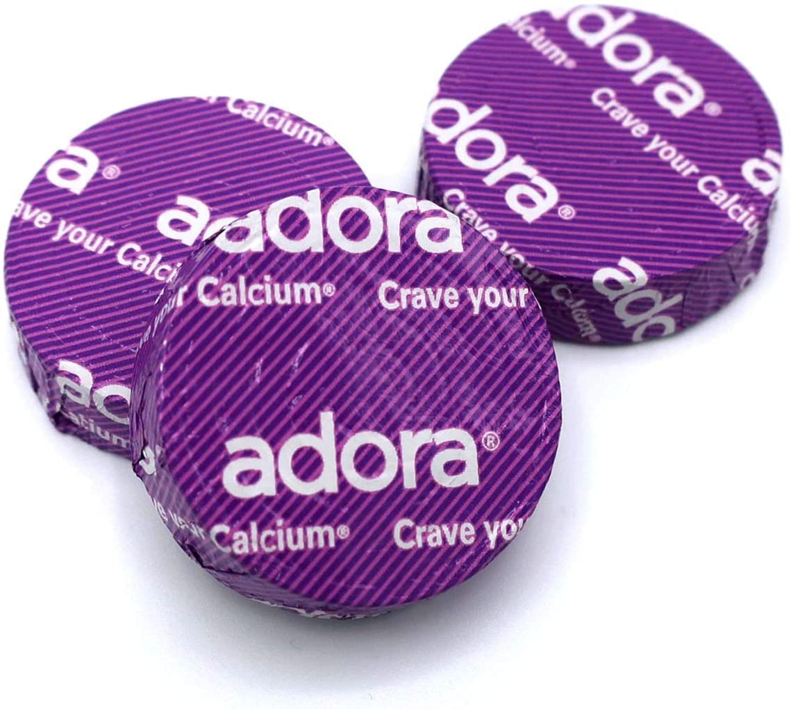 Adora fairtrade dark chocolate disk close-up, premium flavor and ethical sourcing.