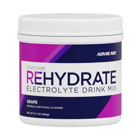 AdvoCare Rehydrate grape powder being poured into a glass for quick hydration.