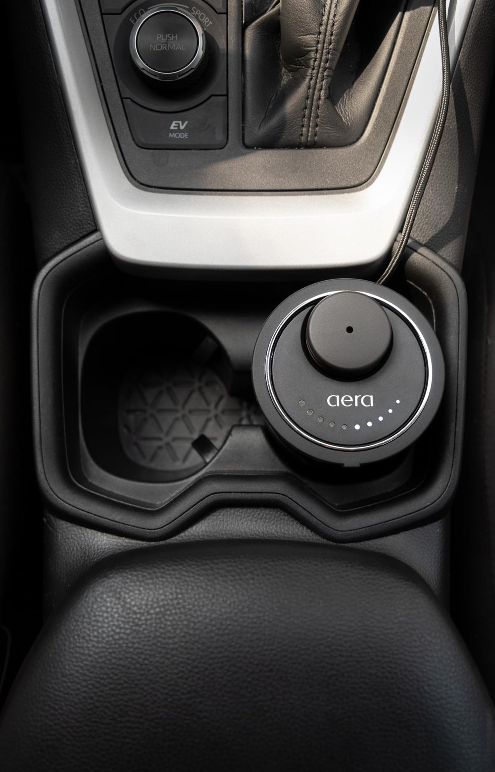 Aera Go Car Diffuser adjustable dial for personalized aroma levels.
