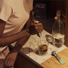 Nighttime routine setup with AGZ Sleep Drink on a bedside table