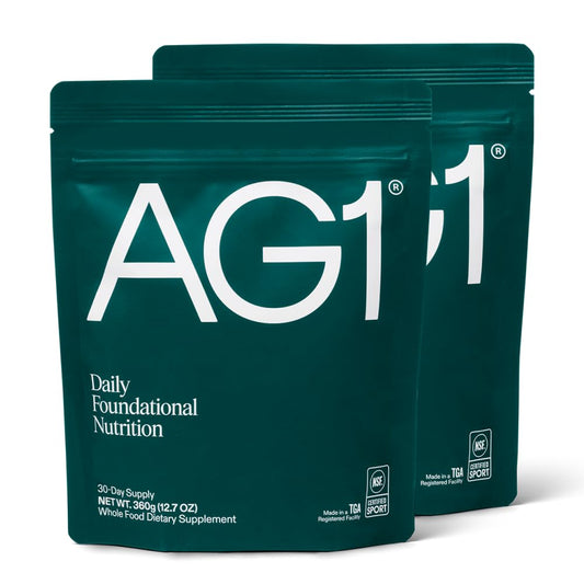 AG1 classic formula bottle with scoop illustrates convenient daily nutrition.