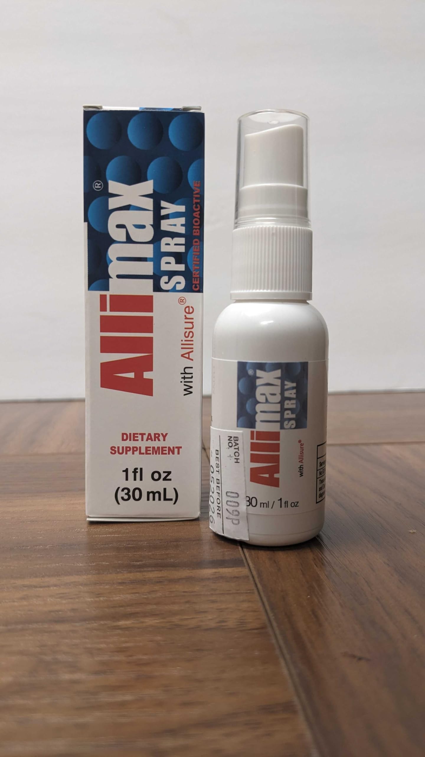A user applying Allimax Rescue Spray to mouth and throat