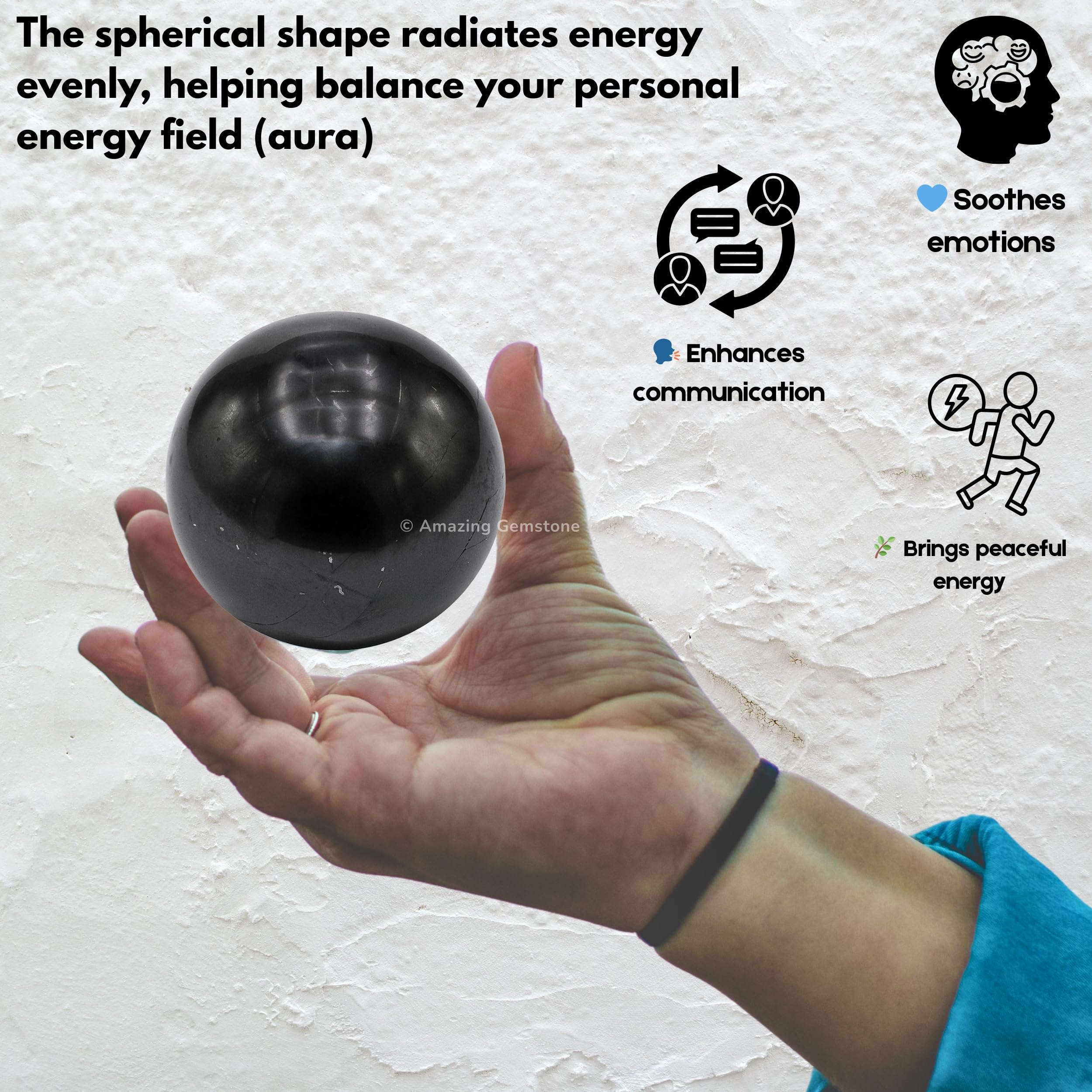 Shungite ball on shelf adds dark modern focal point.