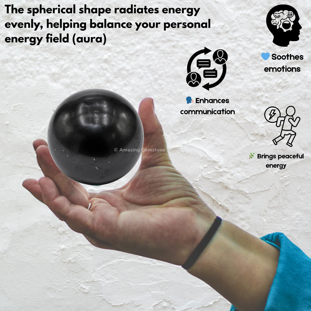 Shungite ball on shelf adds dark modern focal point.