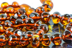 Amber Touch adult necklace worn to complement casual and formal outfits