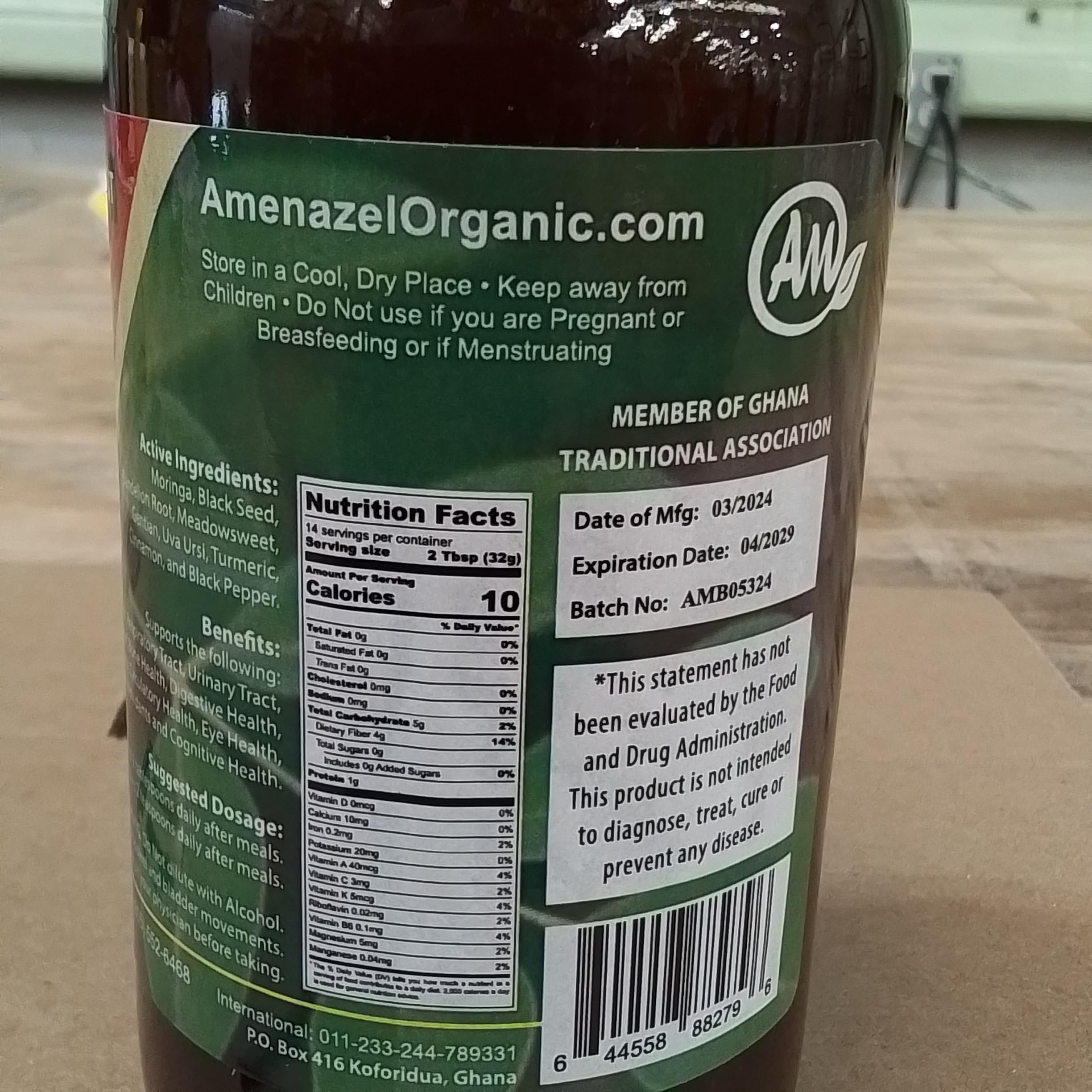 Amenazel Moringa Bitters glass with bottle and herbs conveys natural wellness.