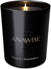 ANAWBE Pine & Clementine candle close-up in black vessel with warm glow for cozy ambiance.