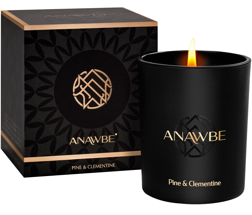 ANAWBE Pine & Clementine candle in black vessel with gold foil details for elegant decor.