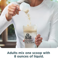 Ancient Nutrition shake with water poured beside glass, inviting easy protein use.