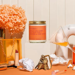 Anecdote Candles glass jar in room setting evokes cozy home ambience.