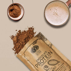 Anima Mundi chocolate protein powder in a vibrant smoothie glass
