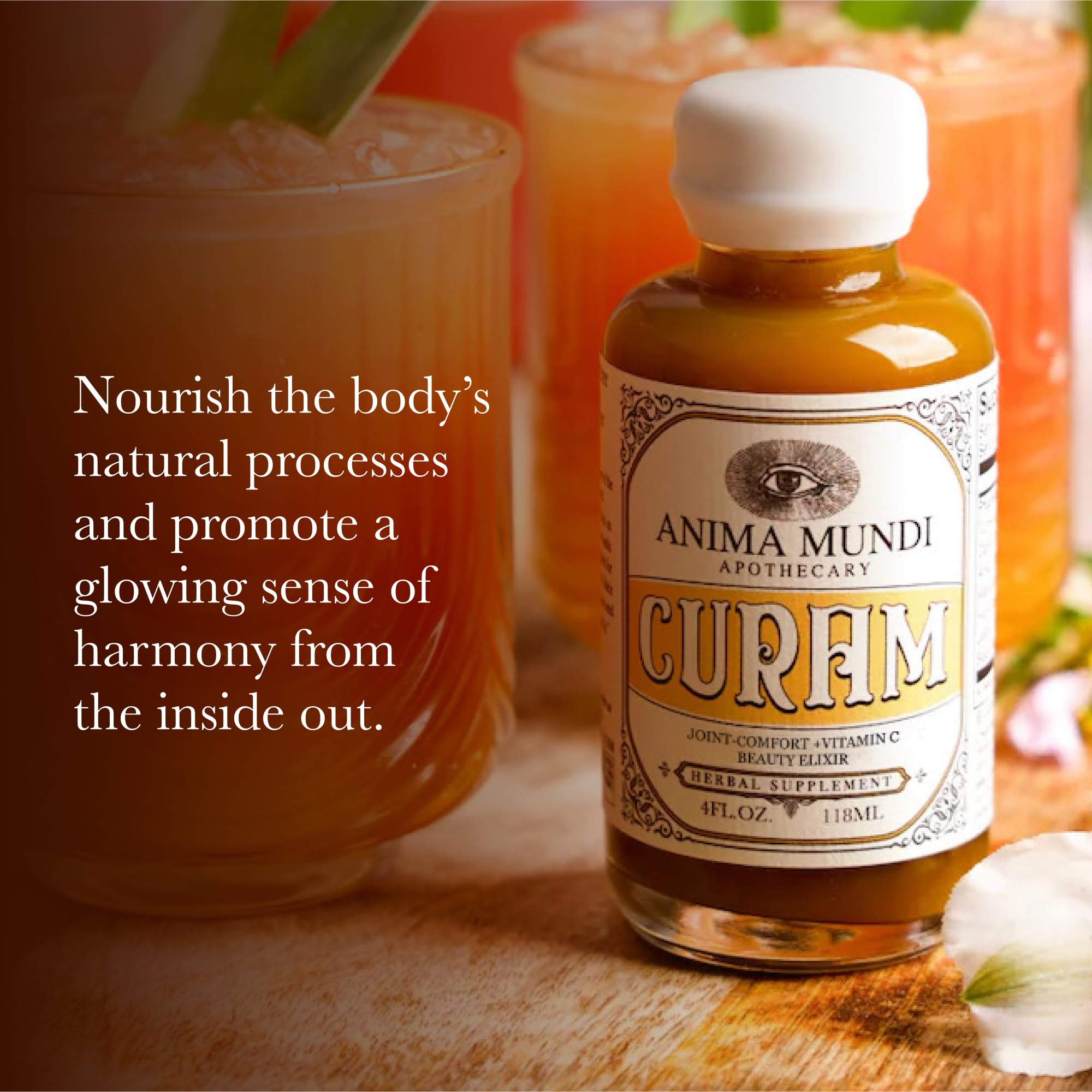 Anima Mundi Curam amber bottle closeup highlighting turmeric and botanicals.