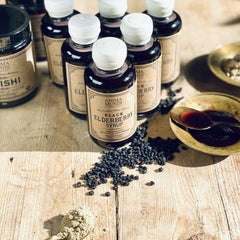 Anima Mundi elderberry and ginger syrup near a natural backdrop for daily use.