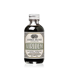 Anima Mundi Viridem Detox bottle pouring for daily cleansing ritual.