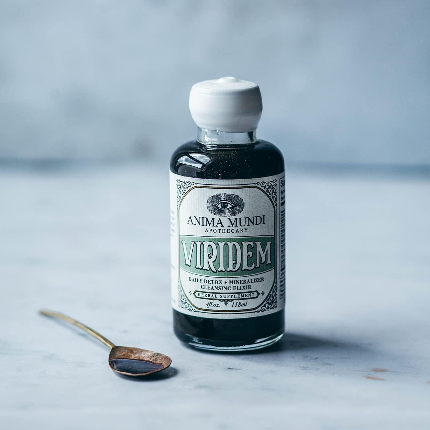 Anima Mundi Apothecary Viridem Greens Detox Elixir pour shows easy juice addition.