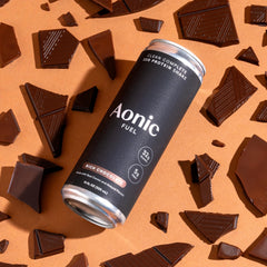 AONIC Fuel 11 oz serving shown alongside a glass of milk