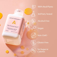 Peach flavored The Honest Youth drops sit beside a glass for daily use.