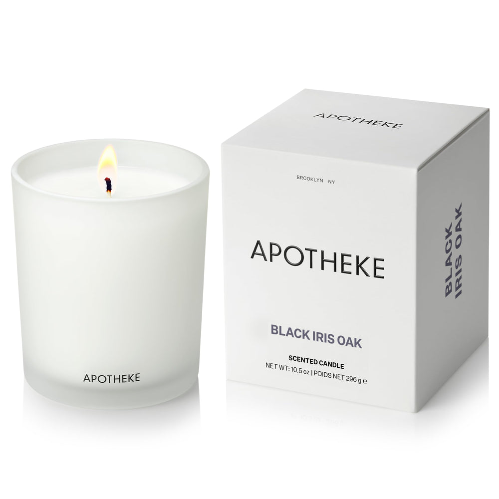APOTHEKE Black Iris Oak candle in a glass jar for a sophisticated living room ambiance.
