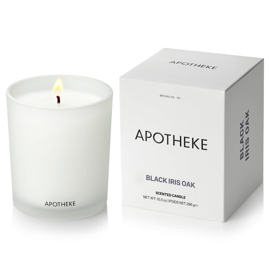 APOTHEKE Black Iris Oak candle in a glass jar for a sophisticated living room ambiance.