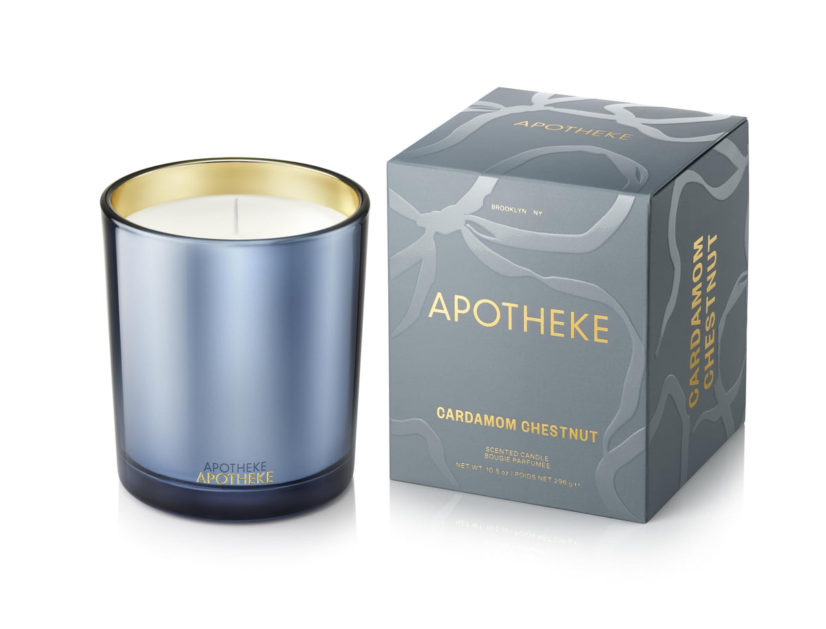 APOTHEKE Cardamom Chestnut candle in blue jar enhances cozy evenings.