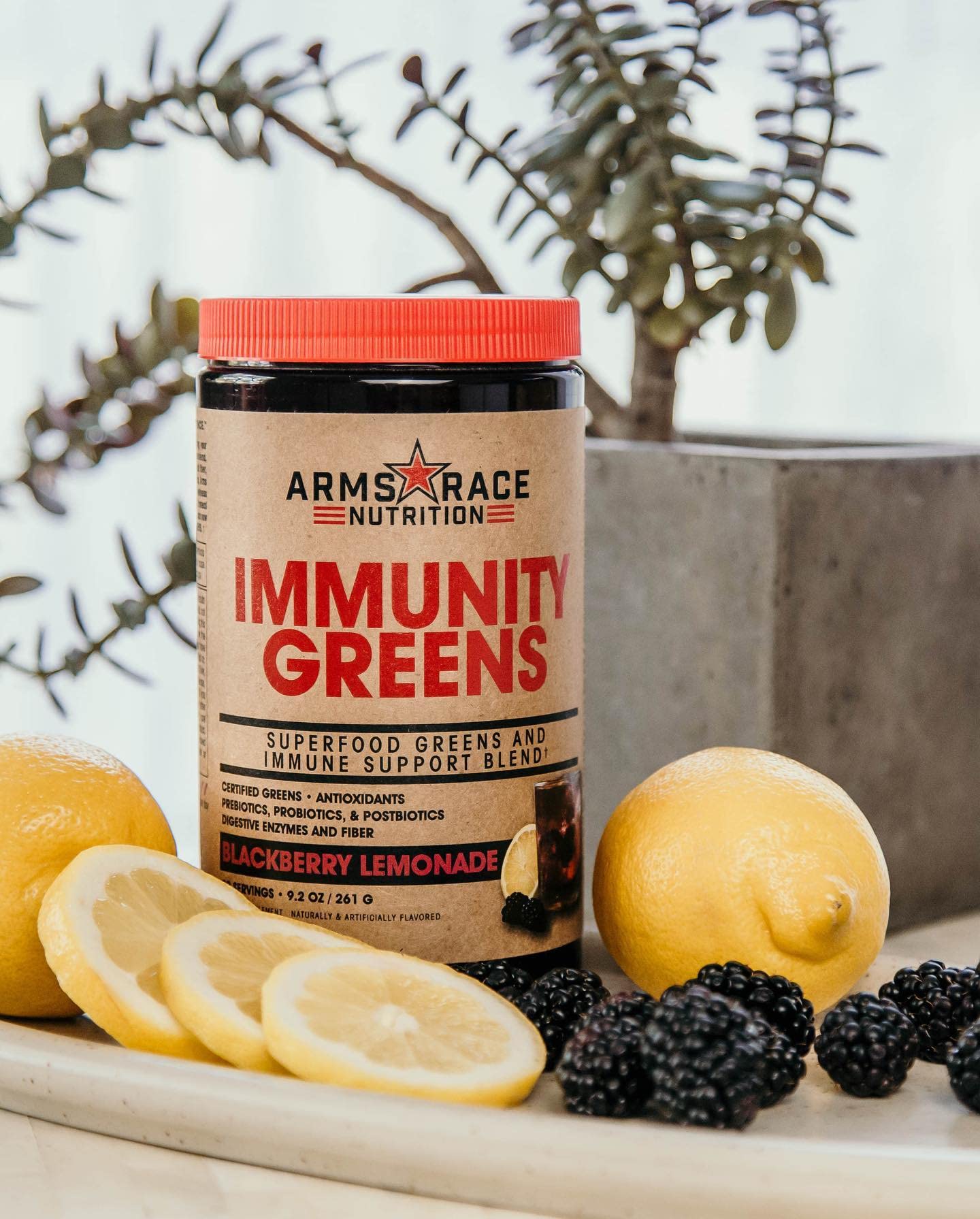 Arms Race Nutrition Immunity Greens bottle side label listing vitamins, minerals, and probiotic benefits.