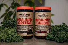 Arms Race Immunity Greens tub label features pineapple mango nutrition and probiotics.