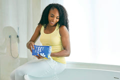 ASUTRA magnesium chloride bath flakes in a warm tub for a soothing soak.