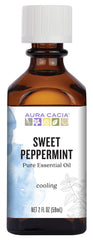Aura Cacia Sweet Peppermint essential oil bottle pour releasing a fresh minty scent
