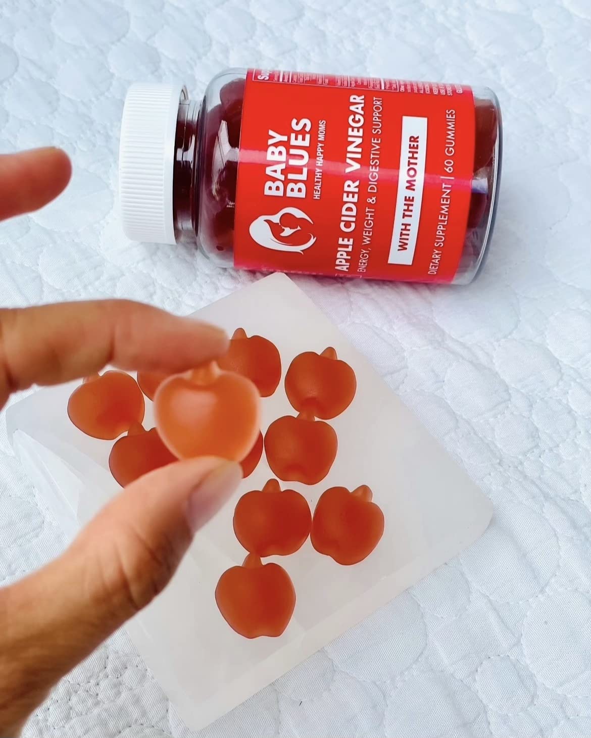 Baby Blues bottle pouring gummies illustrates easy daily postnatal routine.