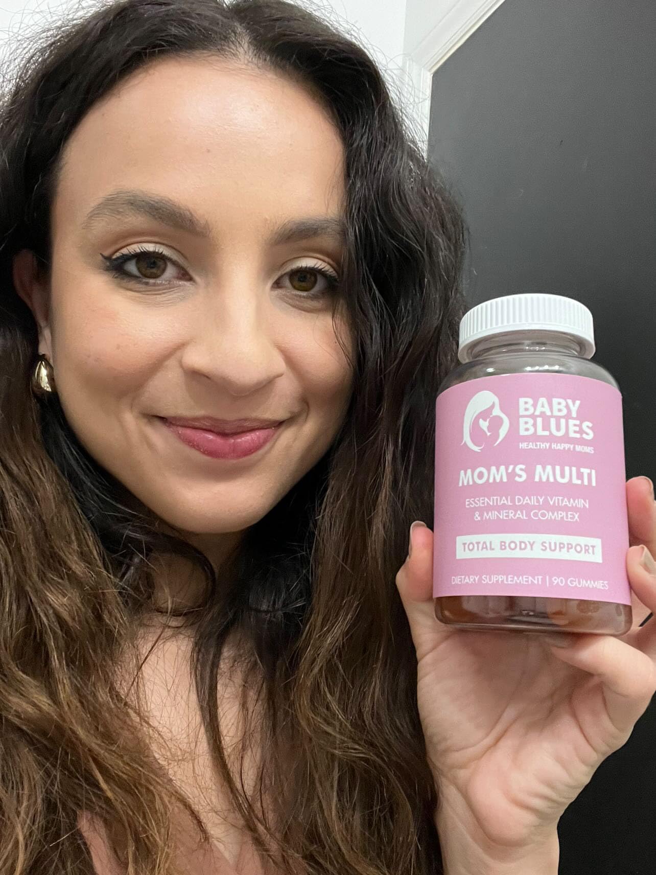 Baby Blues Mom's Multi Daily Gummies in hand for portable daily wellness.