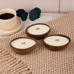 Badalyan Art Studio coconut-shell candle with warm glow in natural shell