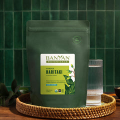Banyan Botanicals Haritaki powder in labeled tin for easy access.