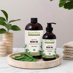 Banyan Botanicals Neem Oil in hand for gentle application.