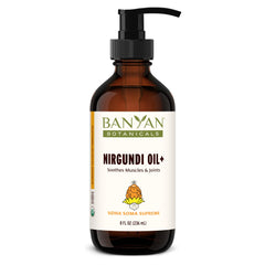 Banyan Botanicals Nirgundi Oil+ bottle pour for relaxing massage and joint comfort.