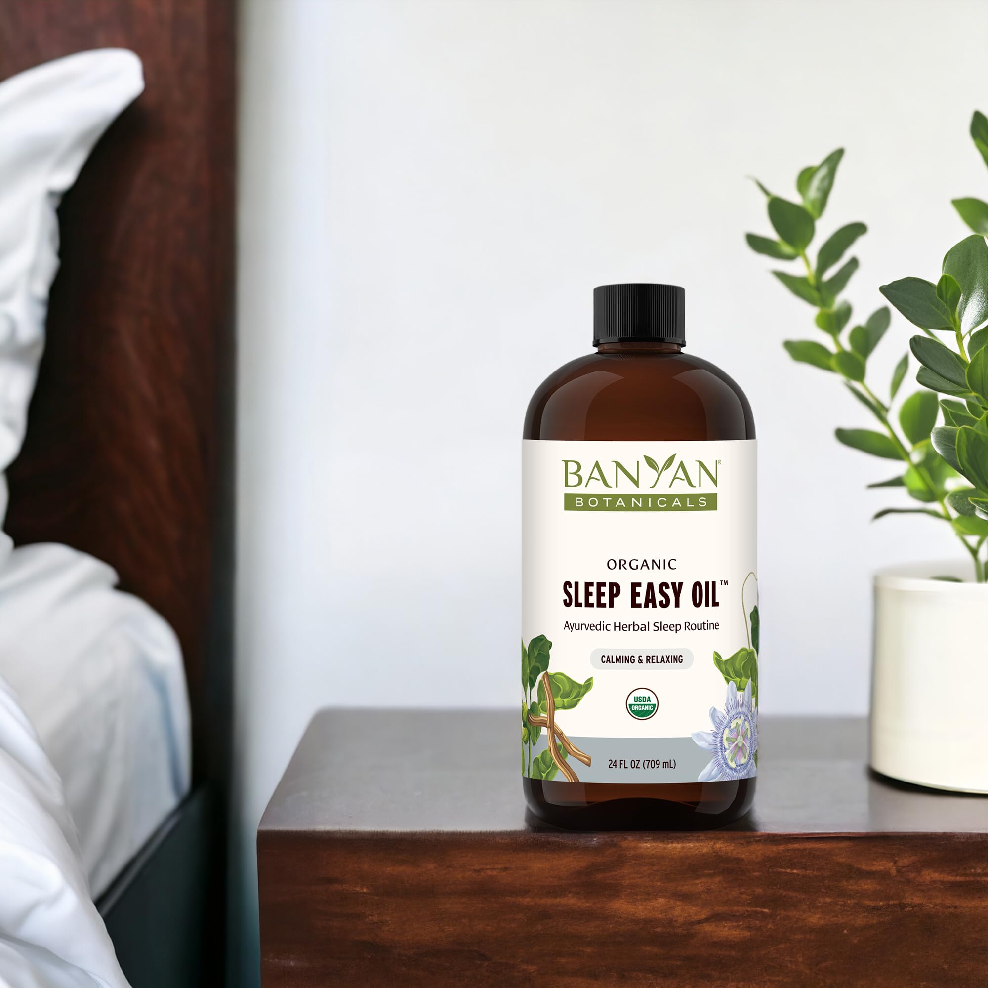 Sleep Easy Oil with ashwagandha and chamomile beside the bottle, highlighting natural ingredients