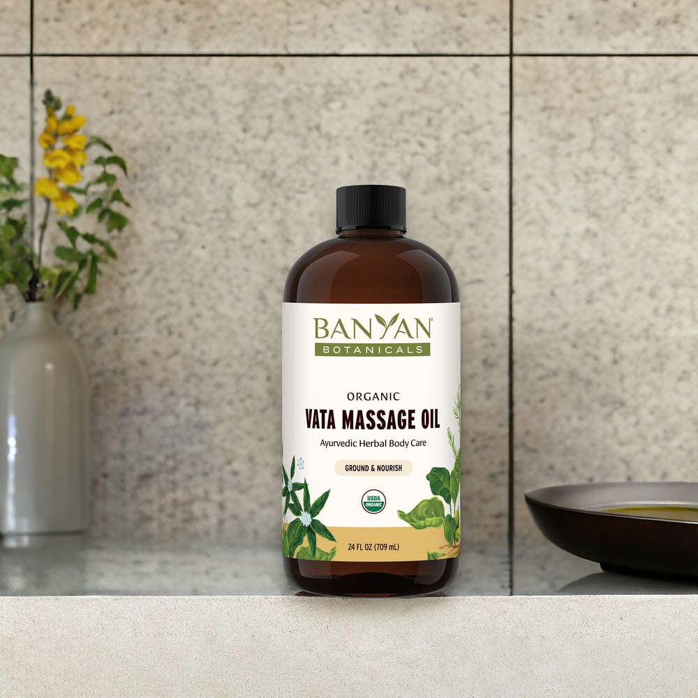 Pouring Banyan Botanicals Vata oil for a silky skin massage